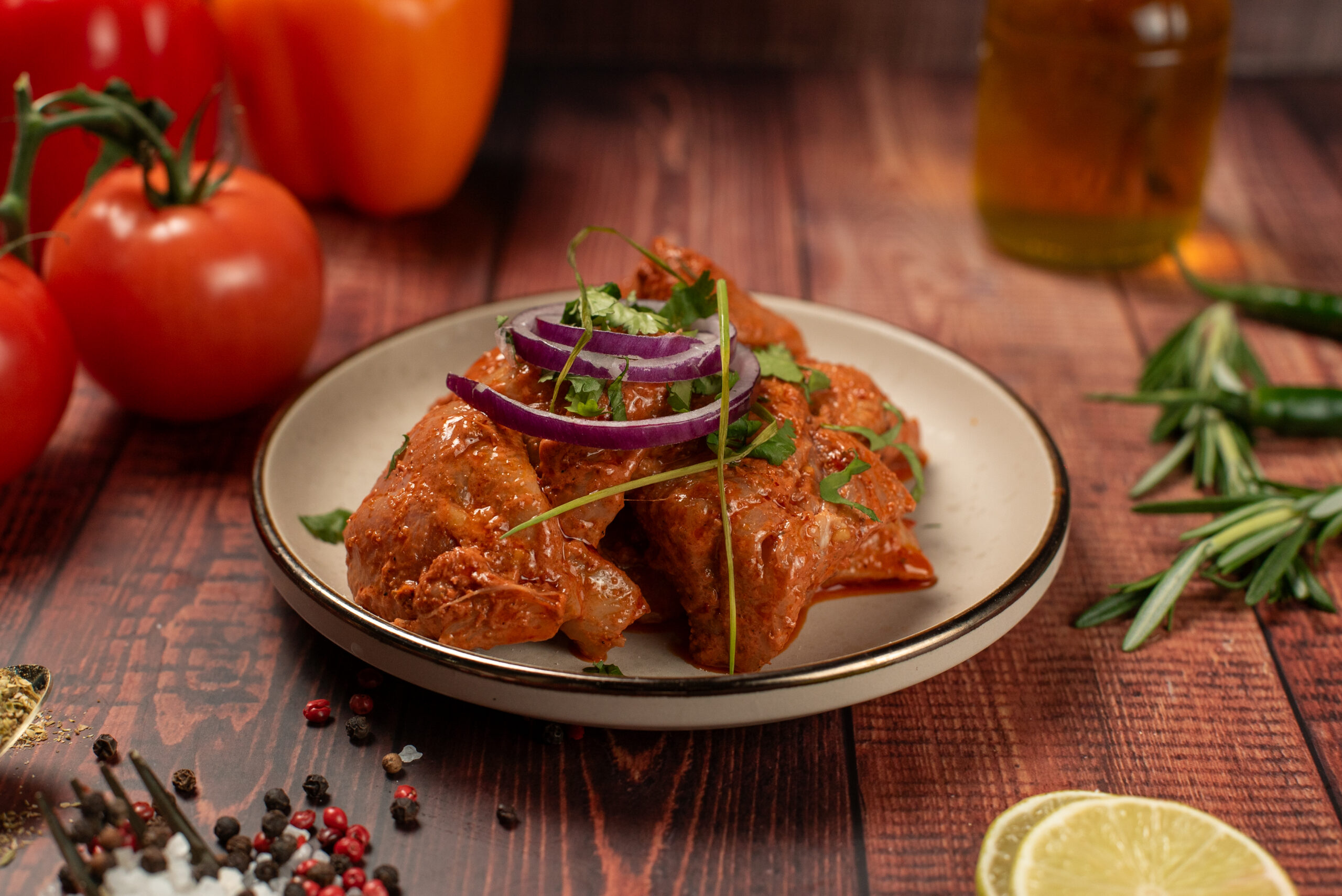 Marinated halal chicken pieces plated with onions and herbs
