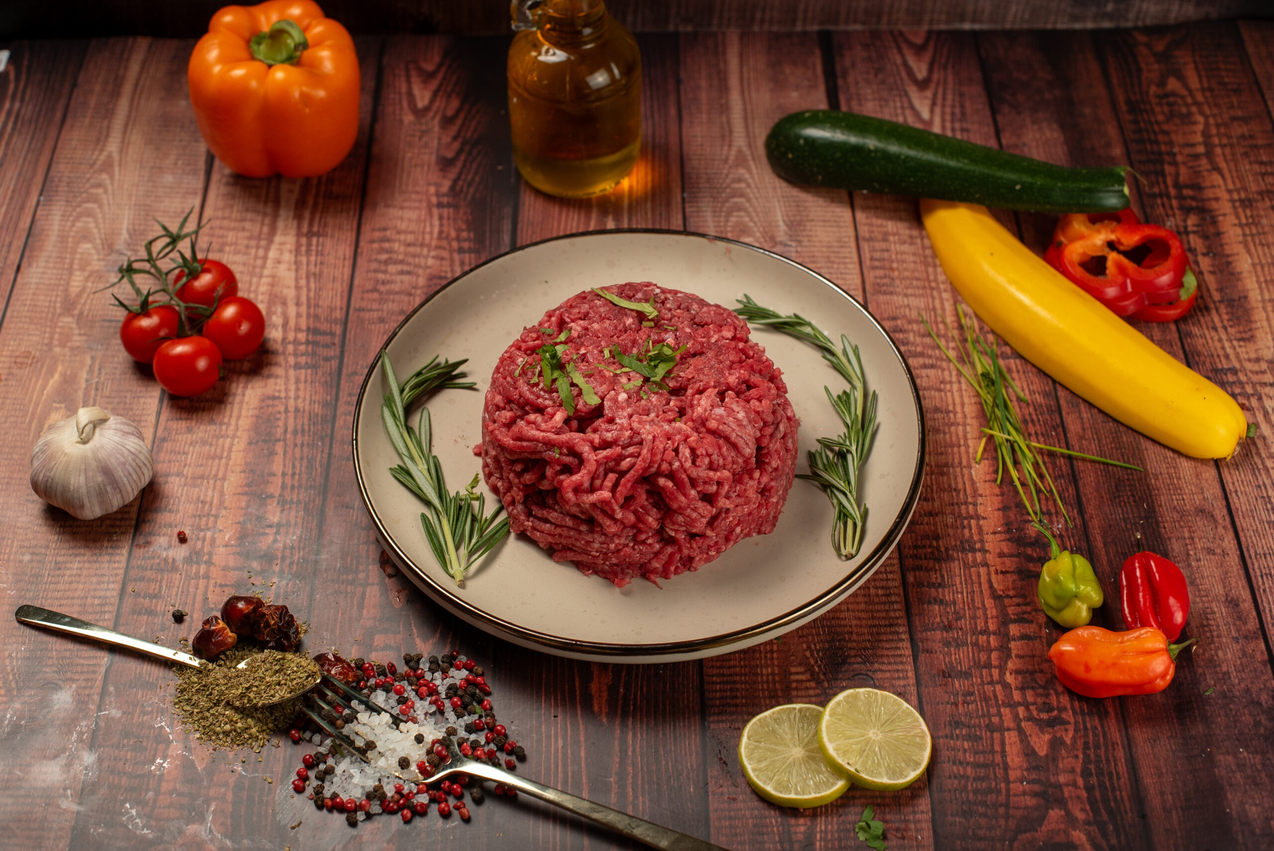 Halal minced lamb formed into round portion with rosemary