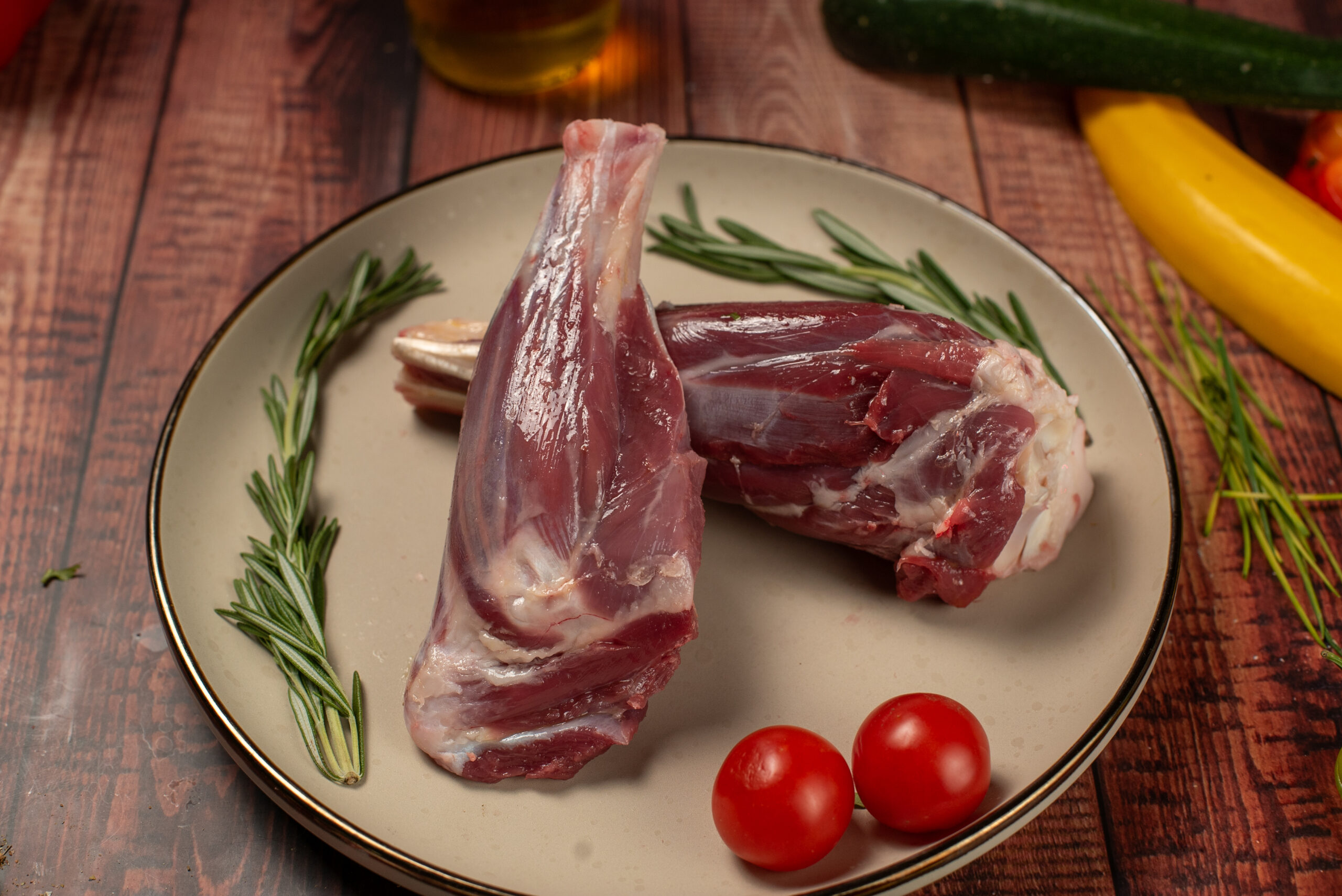 Halal lamb shanks ready for cooking on rustic wooden background
